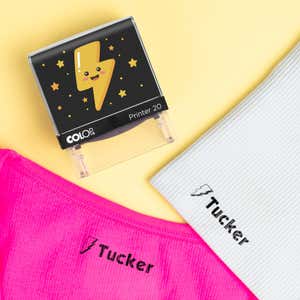 Thunder bolt clothing name stamp beside pink and white shirts labeled Tucker