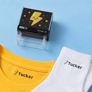 Thunder bolt clothing name stamp with a yellow shirt and white socks labeled Tucker