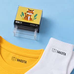 Tiger clothing name stamp with a yellow shirt and white socks labeled Dakota