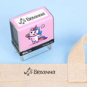 Unicorn clothing name stamp beside a canvas tote bag labeled Breanna