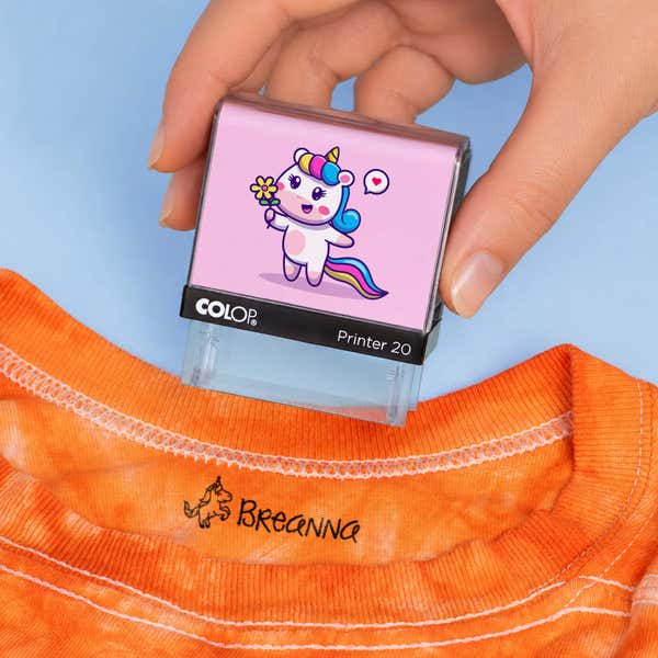 Unicorn clothing name stamp above an orange shirt collar labeled Breanna
