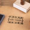 Wood handle logo stamp making boho fashion impression on kraft paper