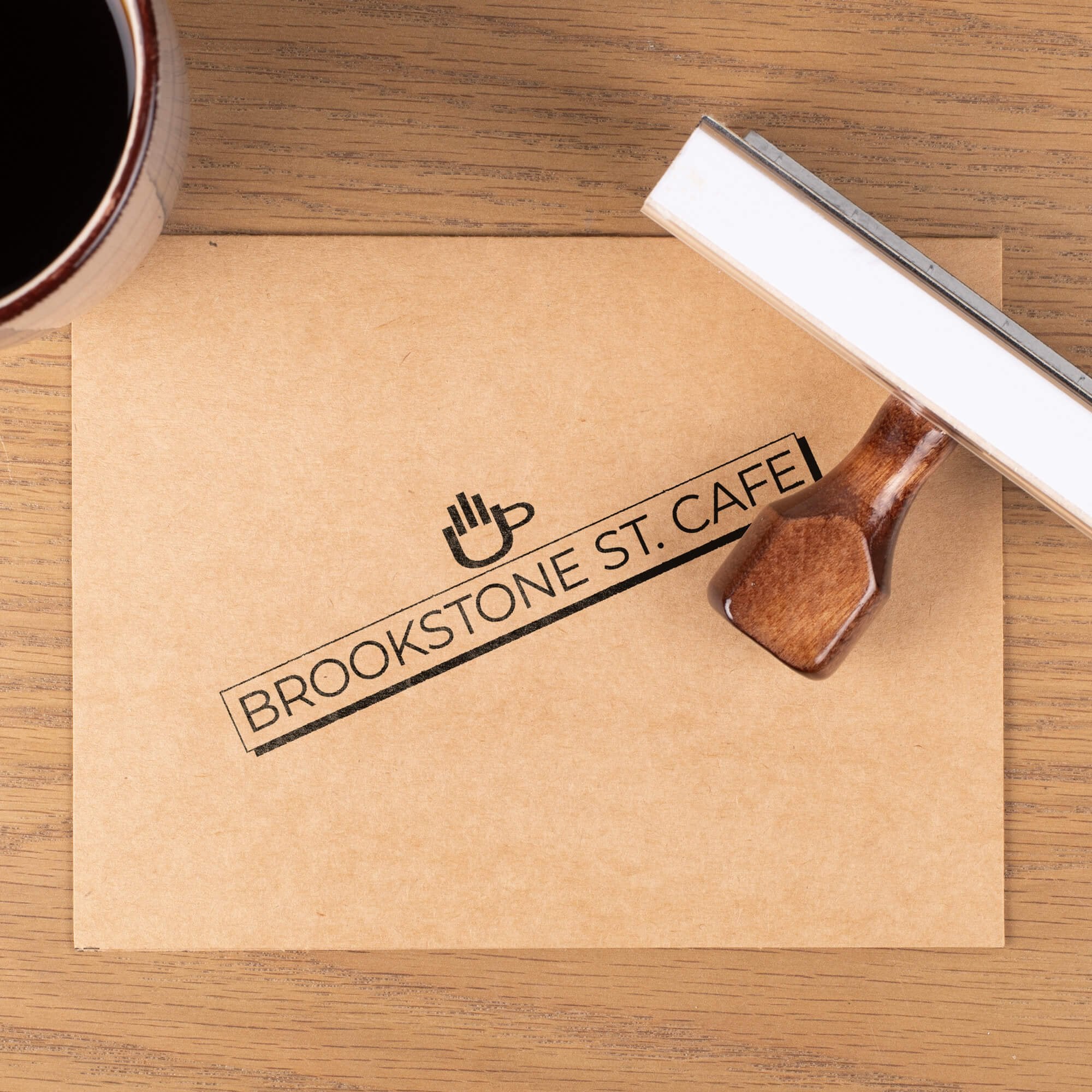 1" x 4" wooden rubber stamp with custom cafe logo on kraft paper card