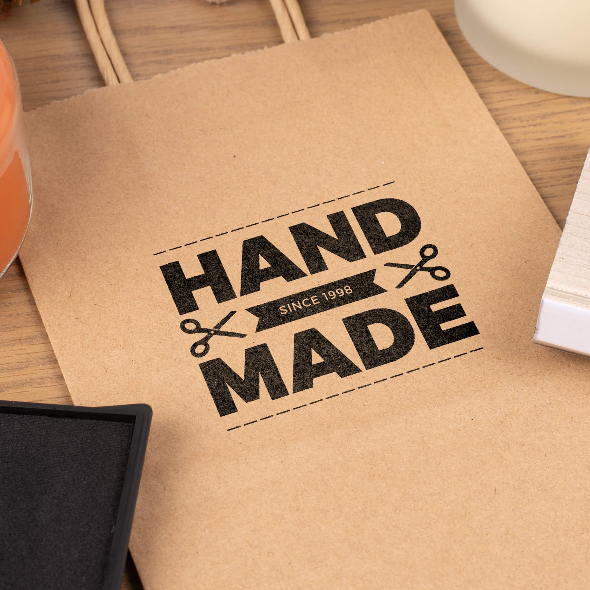 wooden rubber stamp creating handmade branding impression on paper bag