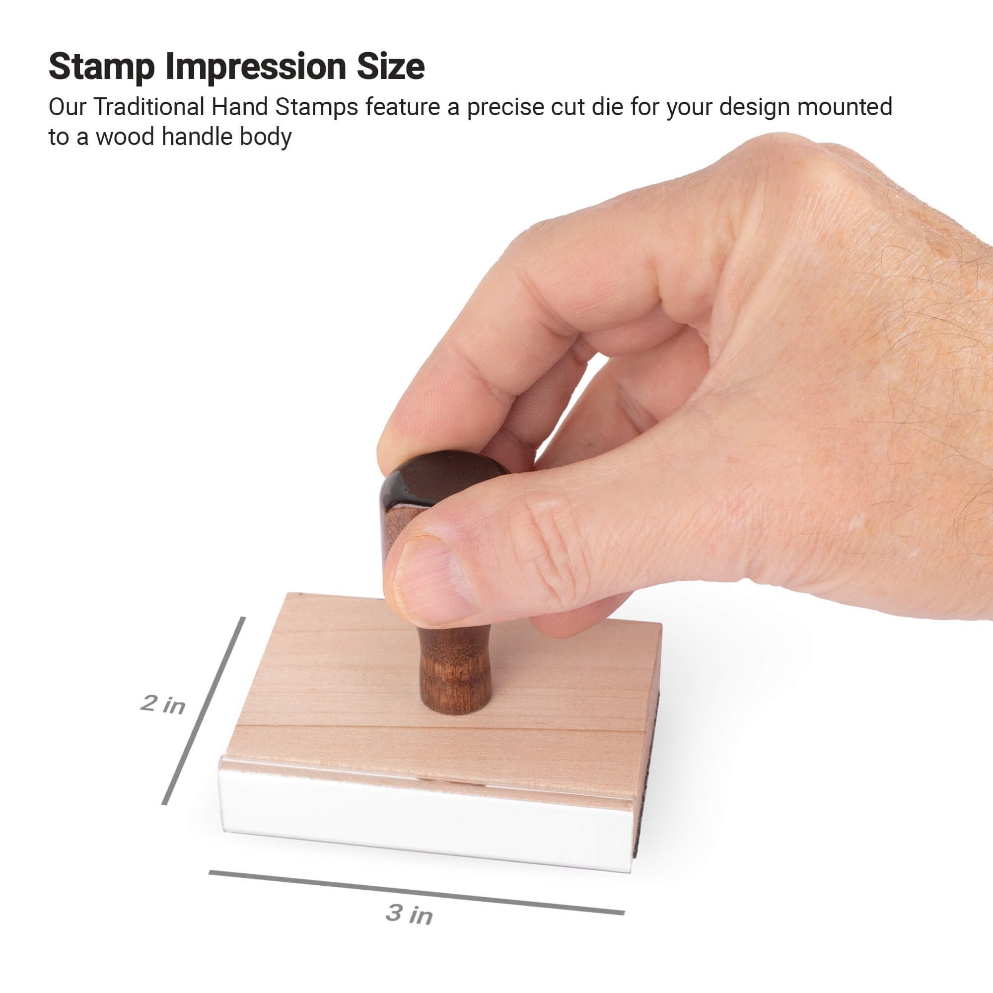 Hand holding a traditional wood handle stamp showing 2x3 inch impression size. Hand holding a traditional wood handle stamp showing 2x3 inch impression size.