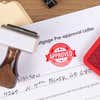 Approved custom stamp in red ink.