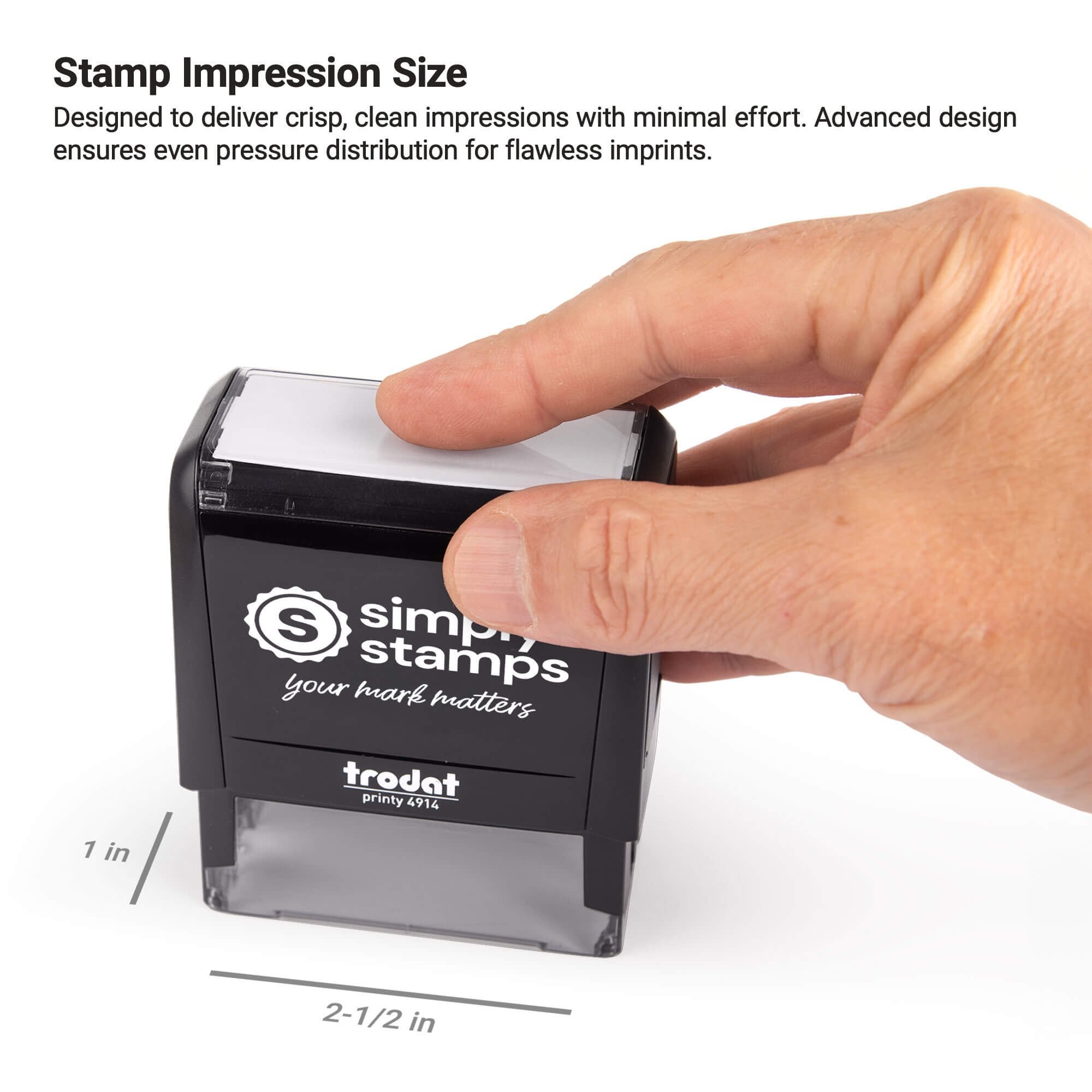 Close-up image of hand pressing a self-inking stamp showing 1 inch by 2.5 inch impression area for clear stamping results.