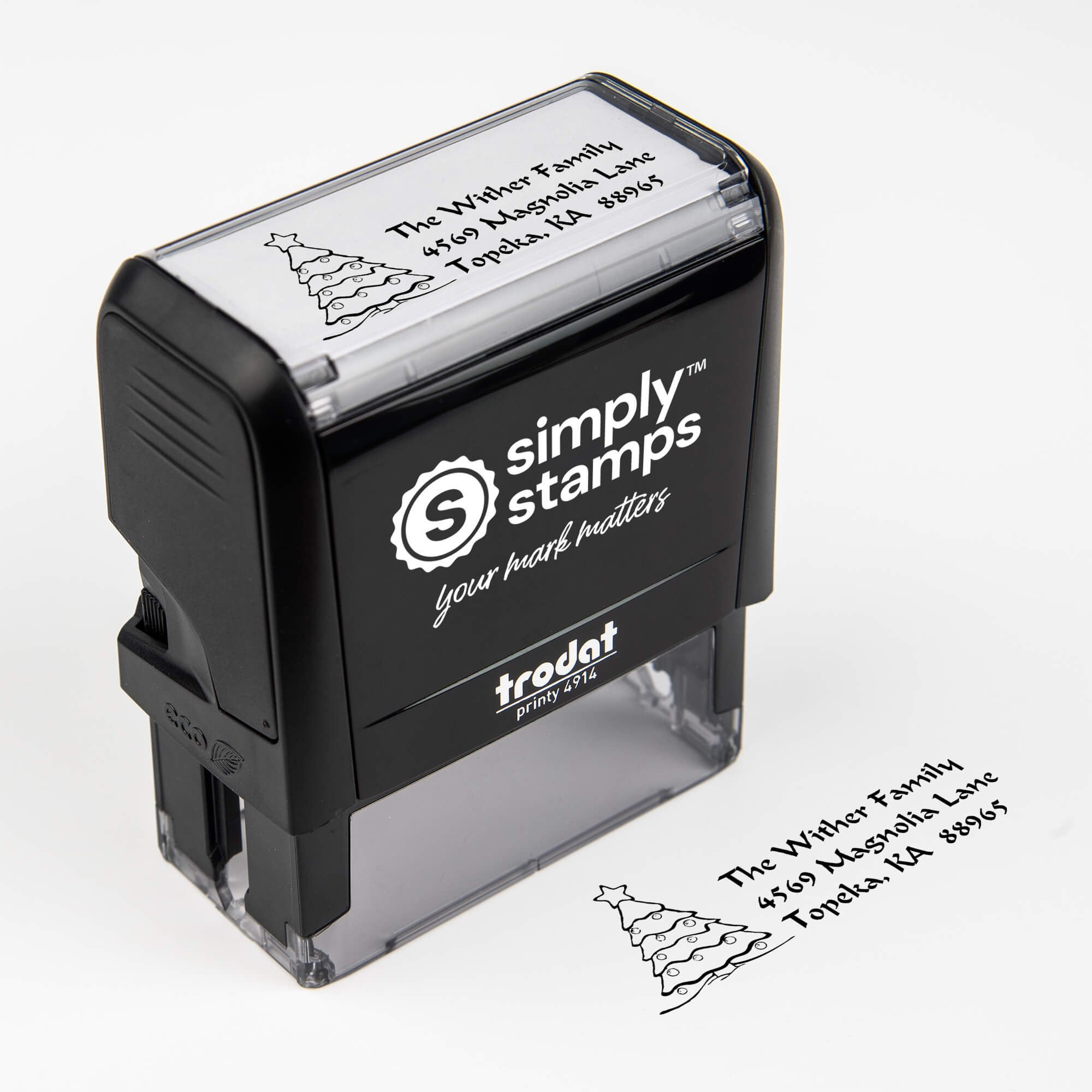 Top angle view of self-inking holiday stamp with circular ‘Christmas Tree Custom’ address design.