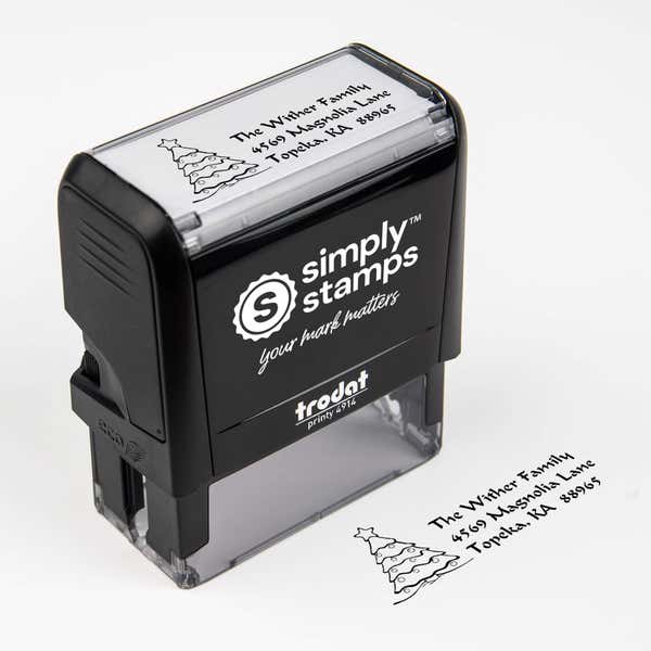 Top angle view of self-inking holiday stamp with circular ‘Christmas Tree Custom’ address design.