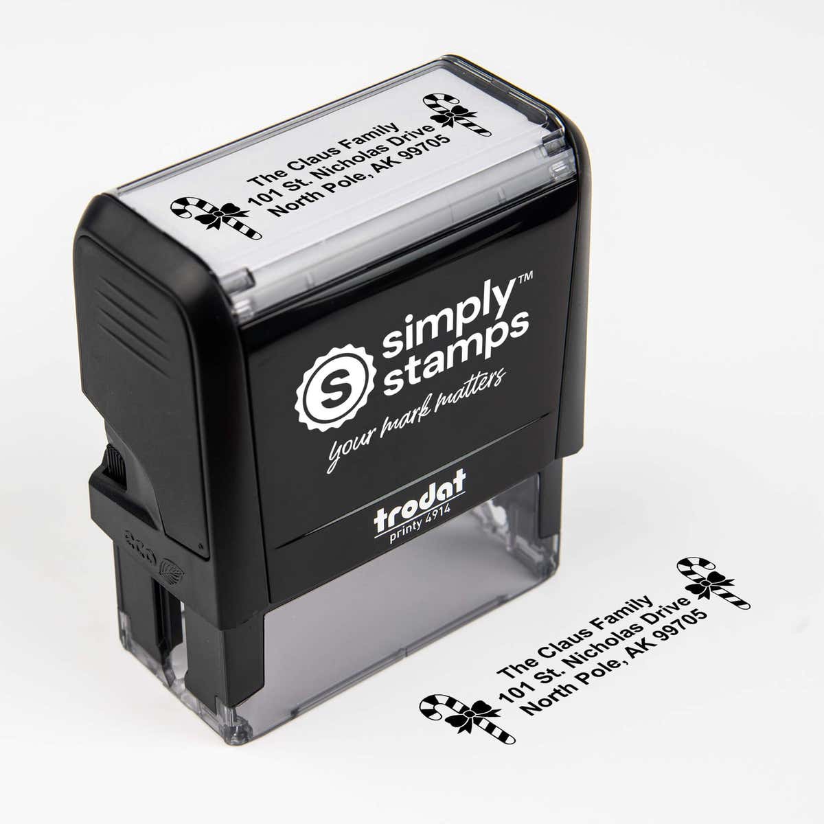 Top angle view of self-inking holiday stamp with circular ‘Bold Candy Canes’ address design.