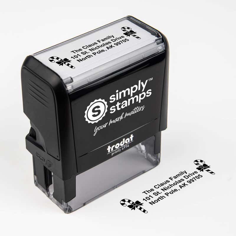 Top angle view of self-inking holiday stamp with circular ‘Bold Candy Canes’ address design.