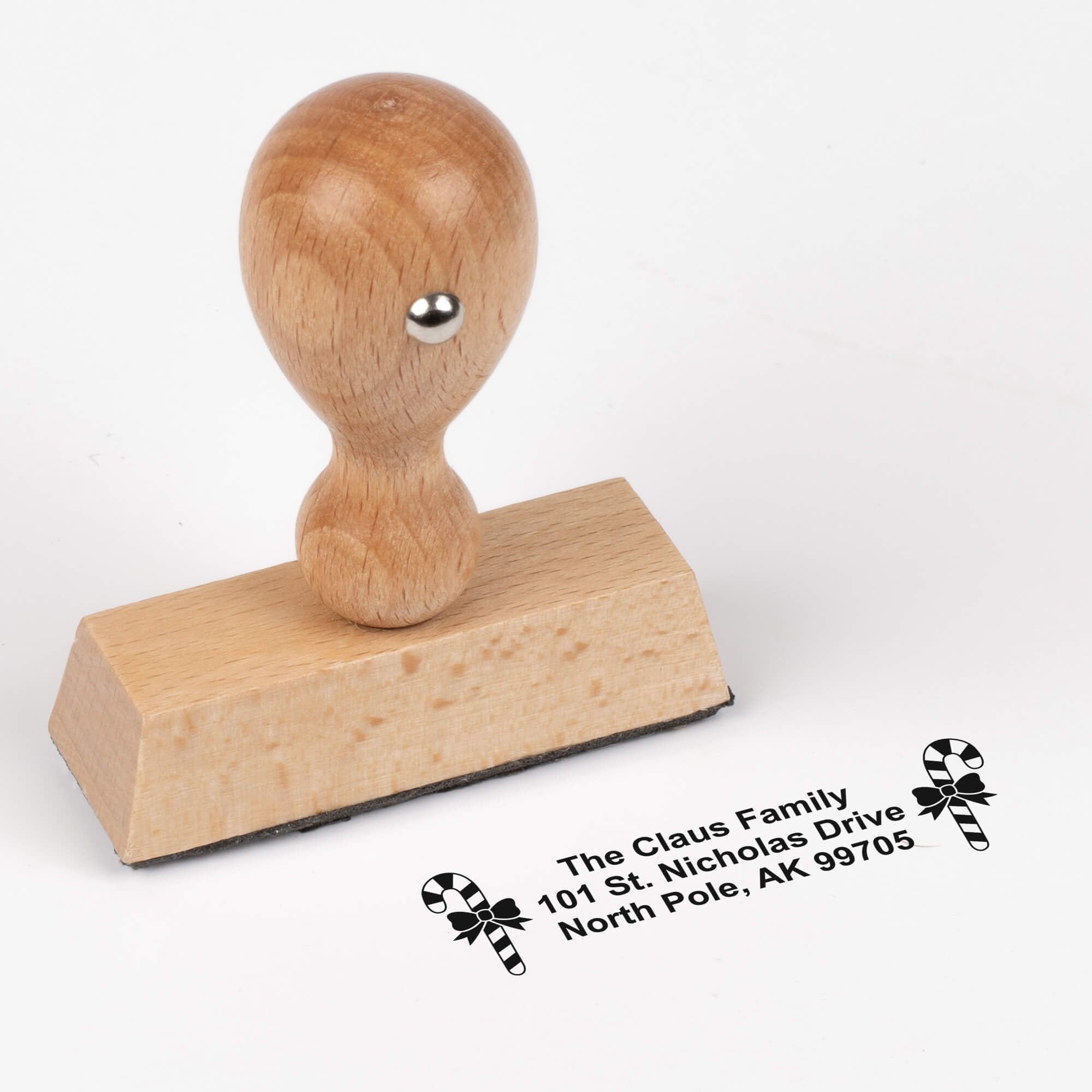 European wood hand stamp shown from above featuring custom ‘Bold Candy Canes’ holiday return address design.
