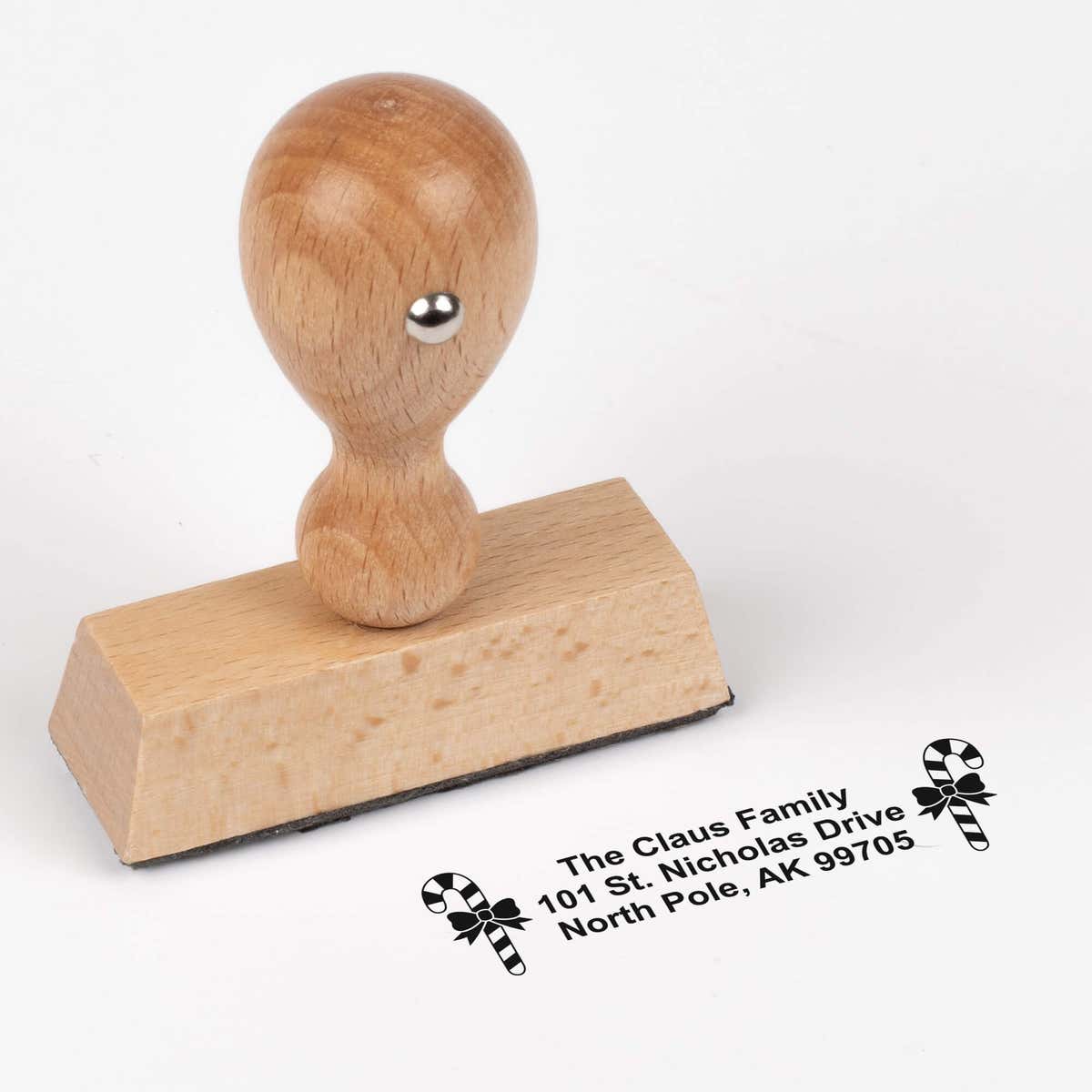 European wood hand stamp shown from above featuring custom ‘Bold Candy Canes’ holiday return address design.
