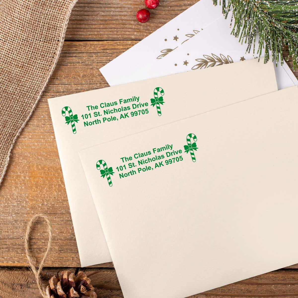Green ink impressions of ‘Bold Candy Canes’ return address stamp on Christmas envelopes.