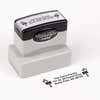 Pre-inked stamp shown from above featuring custom ‘Bold Candy Canes’  holiday return address design.