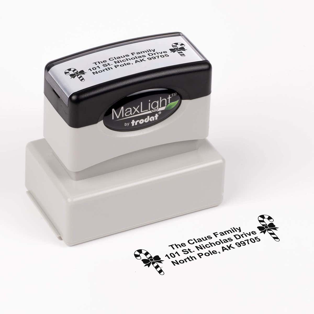 Pre-inked stamp shown from above featuring custom ‘Bold Candy Canes’  holiday return address design.
