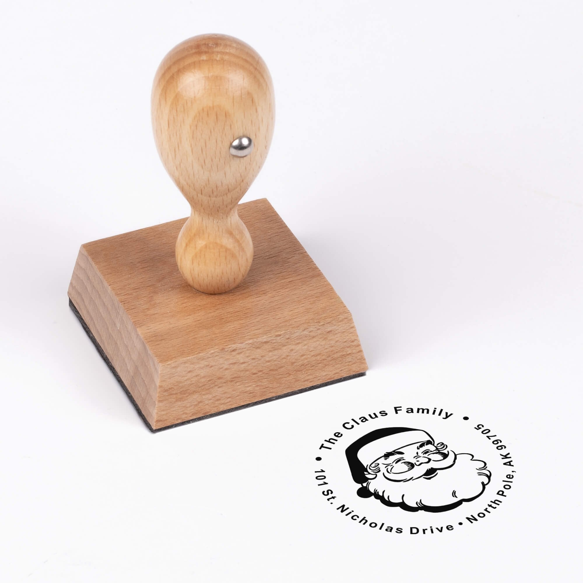 European wood hand stamp shown from above featuring custom ‘Classic Santa’ holiday return address design.