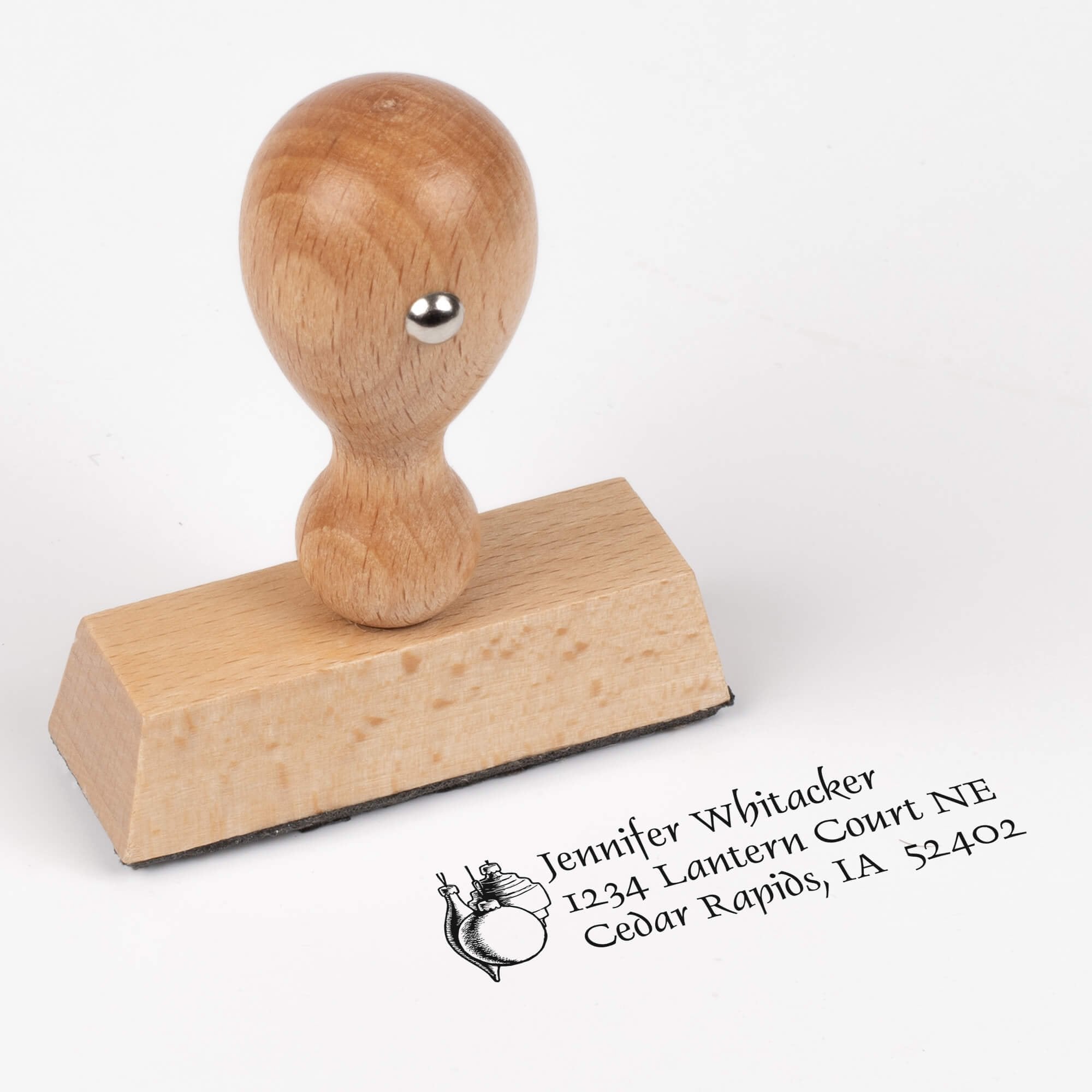 European wood hand stamp shown from above featuring custom ‘Hanging Ornaments’ holiday return address design.