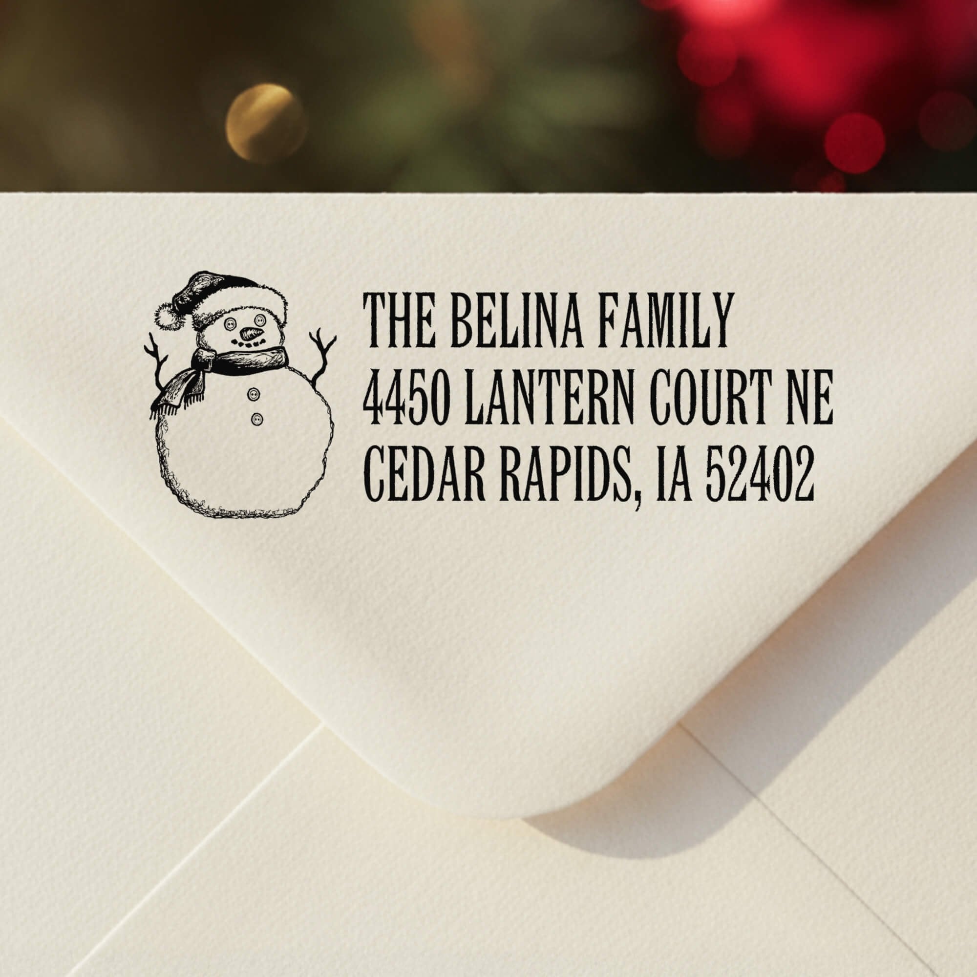 Personalized ‘Sketch Snowman’ address stamp impression on envelope flap for holiday cards.
