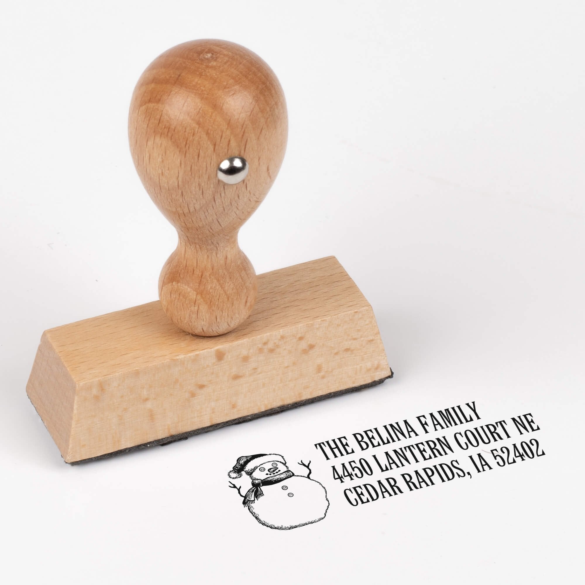 European wood hand stamp shown from above featuring custom ‘Sketch Snowman’ holiday return address design.