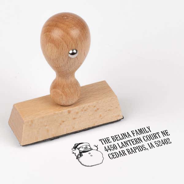 European wood hand stamp shown from above featuring custom ‘Sketch Snowman’ holiday return address design.