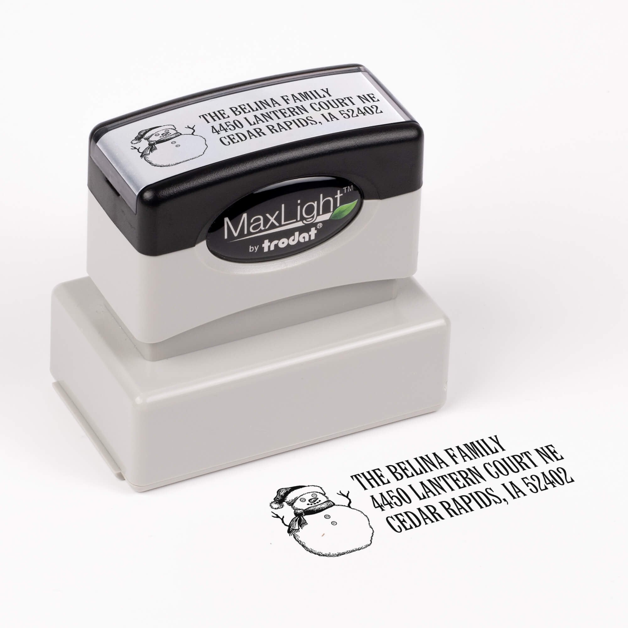 Pre-inked stamp shown from above featuring custom ‘Sketch Snowman’  holiday return address design.