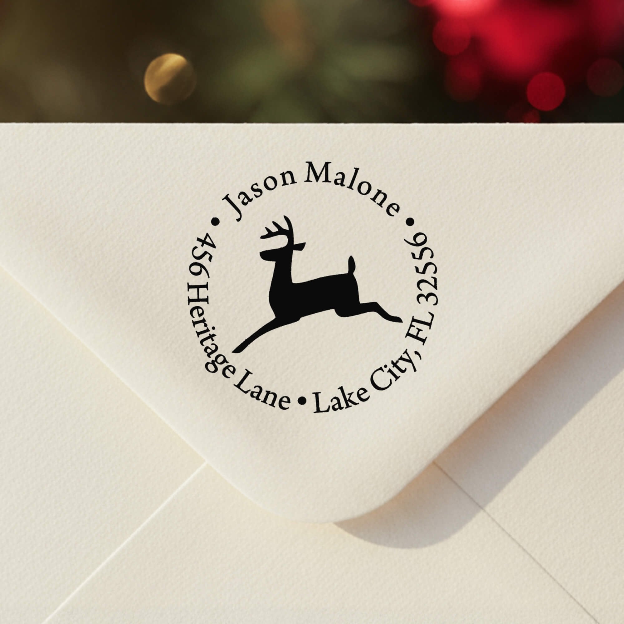 Personalized ‘Leaping Reindeer Holiday’ address stamp impression on envelope flap for holiday cards.