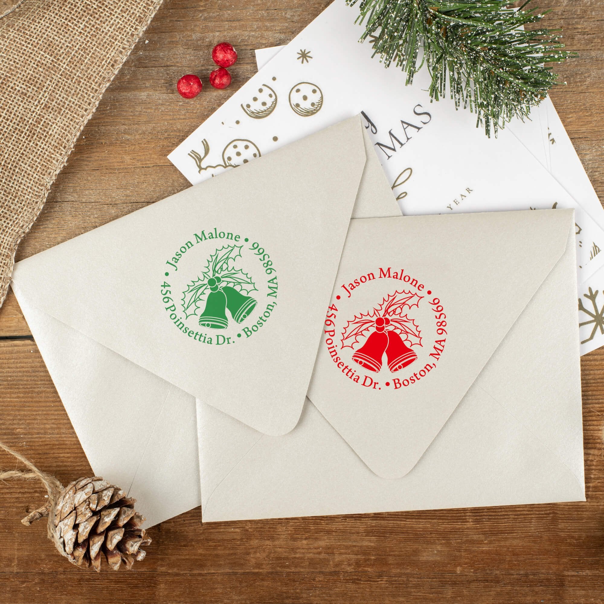 Green and red ink impressions of ‘Holly Bells Holiday’ return address stamp on Christmas envelopes.