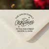 Personalized ‘Merry Christmas with Snowflakes’ address stamp impression on envelope flap for holiday cards.