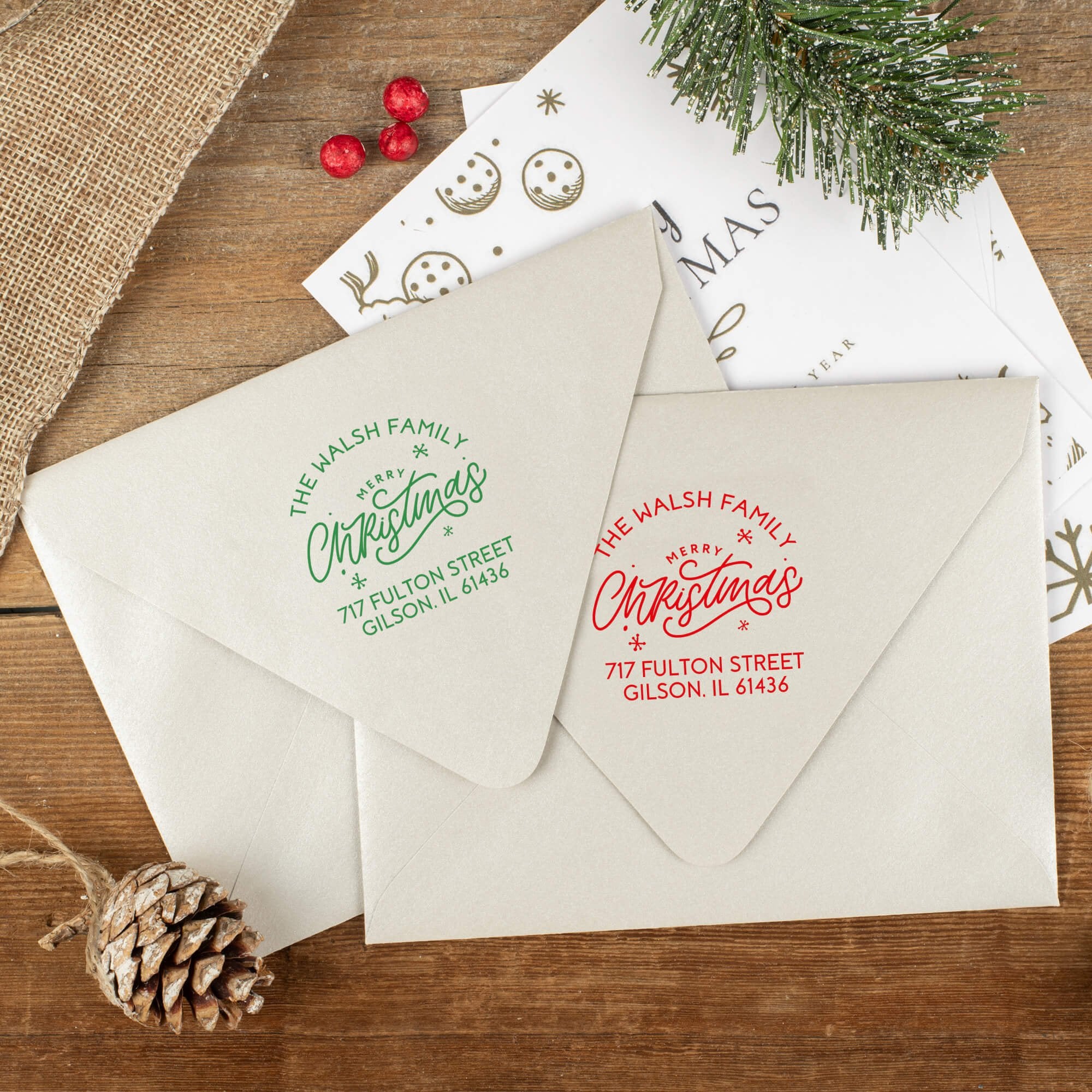 Green and red ink impressions of ‘Merry Christmas with Snowflakes’ return address stamp on Christmas envelopes.