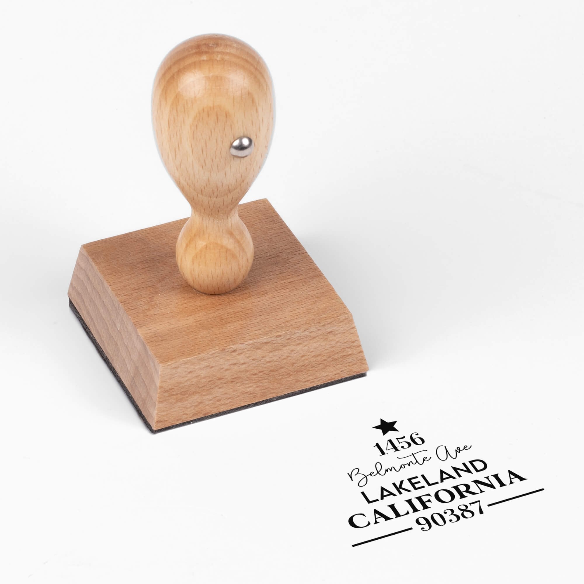 European wood hand stamp shown from above featuring custom ‘Display Christmas Tree’ holiday return address design.