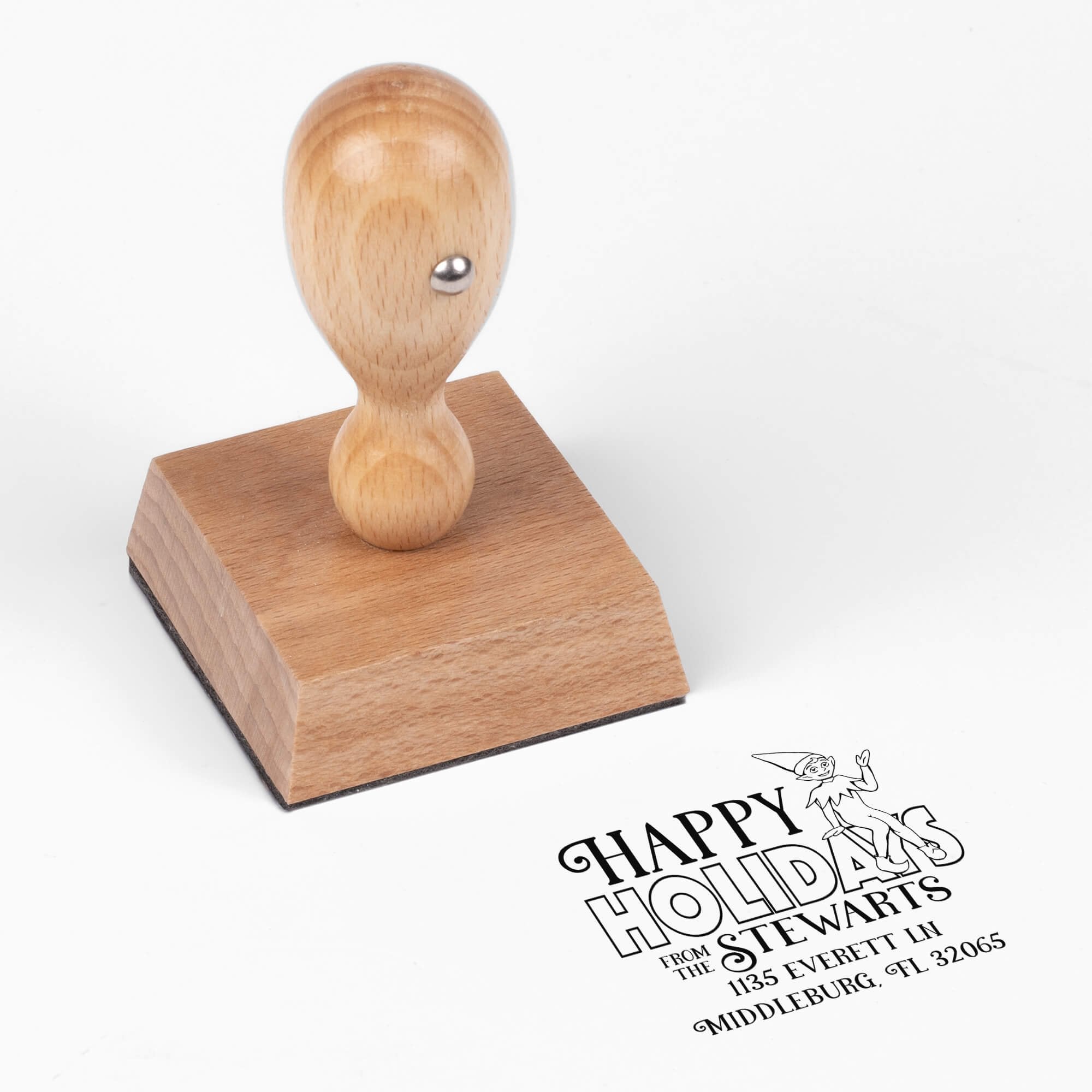 European wood hand stamp shown from above featuring custom ‘Cartoon Elf’ holiday return address design.