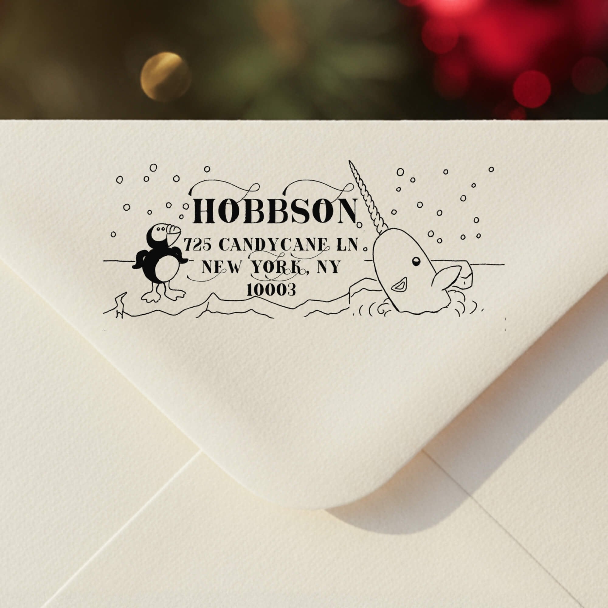 Personalized ‘Cartoon Penguin’ address stamp impression on envelope flap for holiday cards.