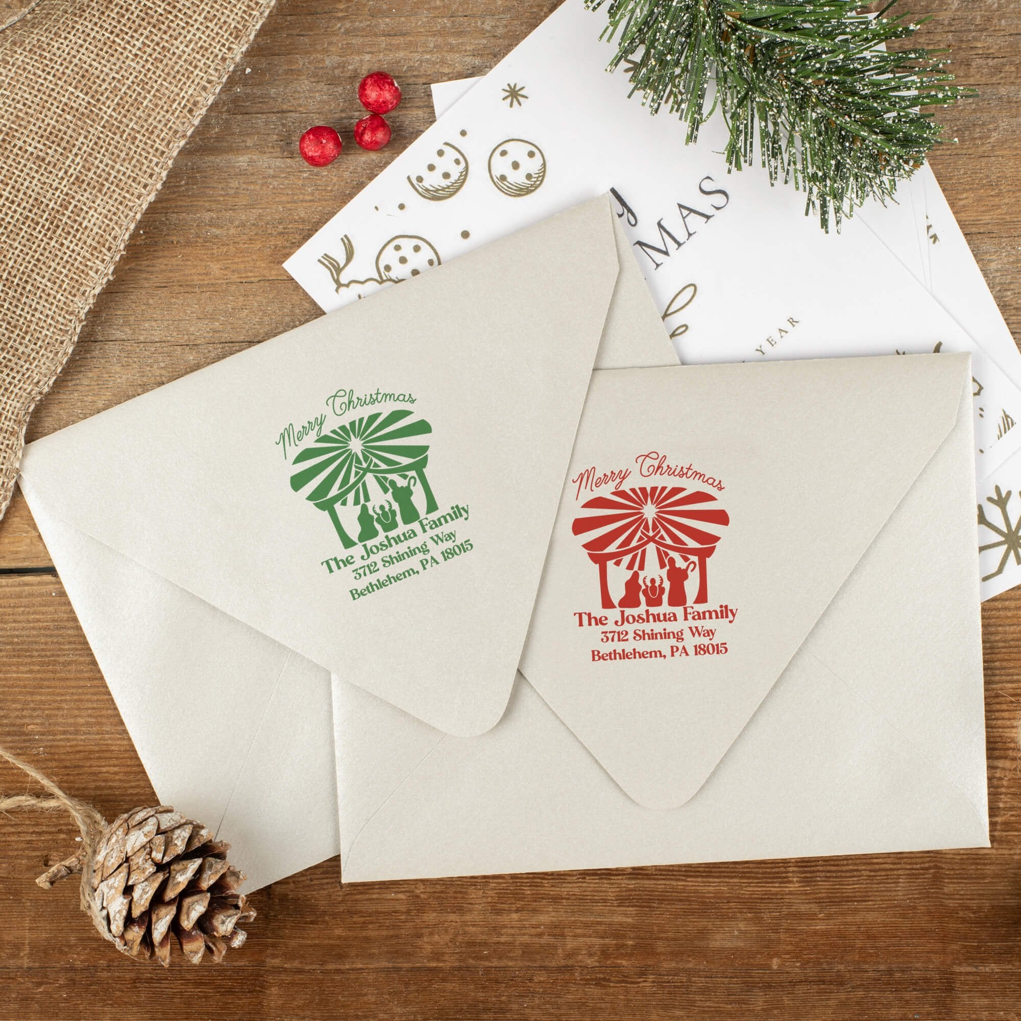 Green and red ink impressions of ‘Nativity Scene’ return address stamp on Christmas envelopes.