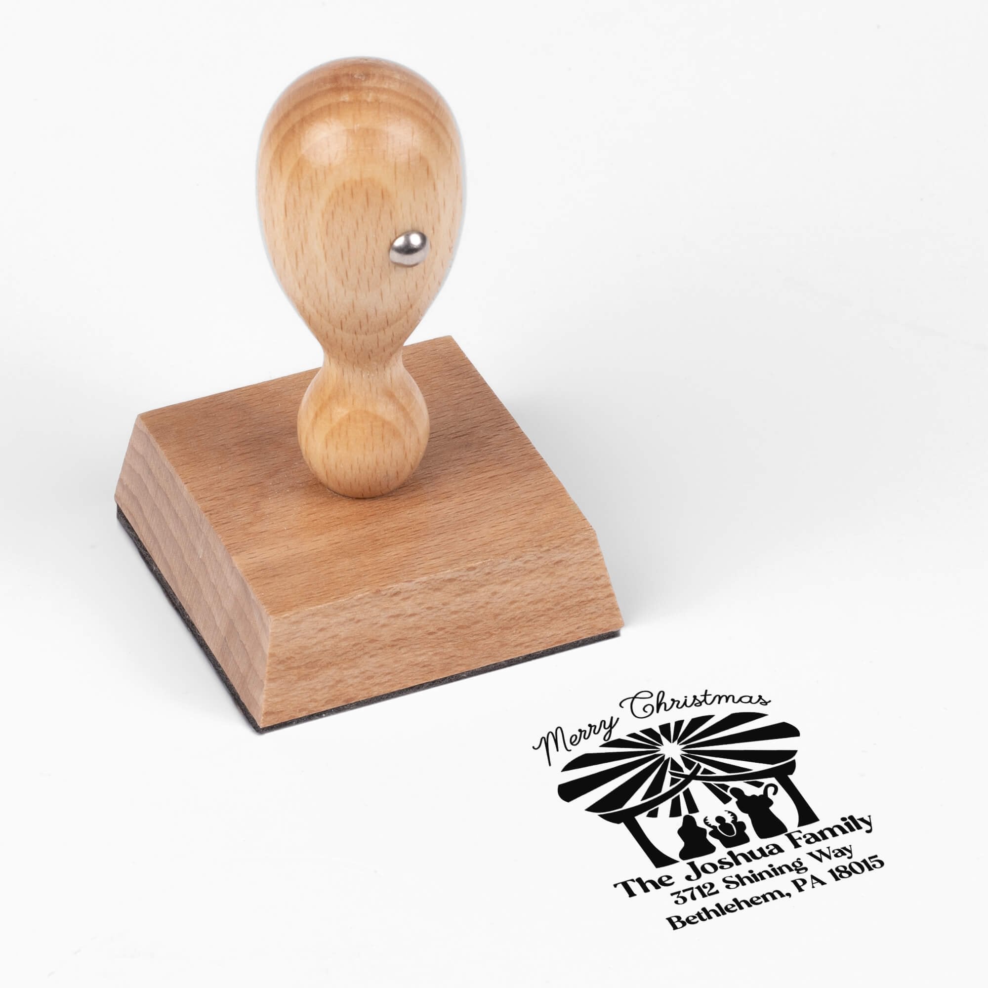 European wood hand stamp shown from above featuring custom ‘Nativity Scene’ holiday return address design.