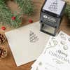 Holiday-themed ‘Cartoon Christmas Tree’ address stamp shown on envelopes beside festive stationery, pinecones, and decorations.