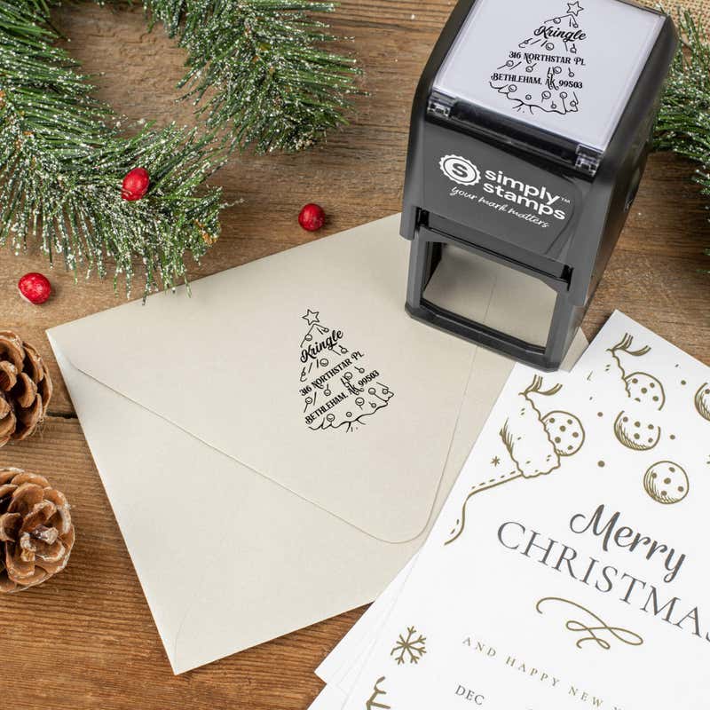 Holiday-themed ‘Cartoon Christmas Tree’ address stamp shown on envelopes beside festive stationery, pinecones, and decorations.