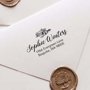 Flower address stamp on a letter with a gold wax seal