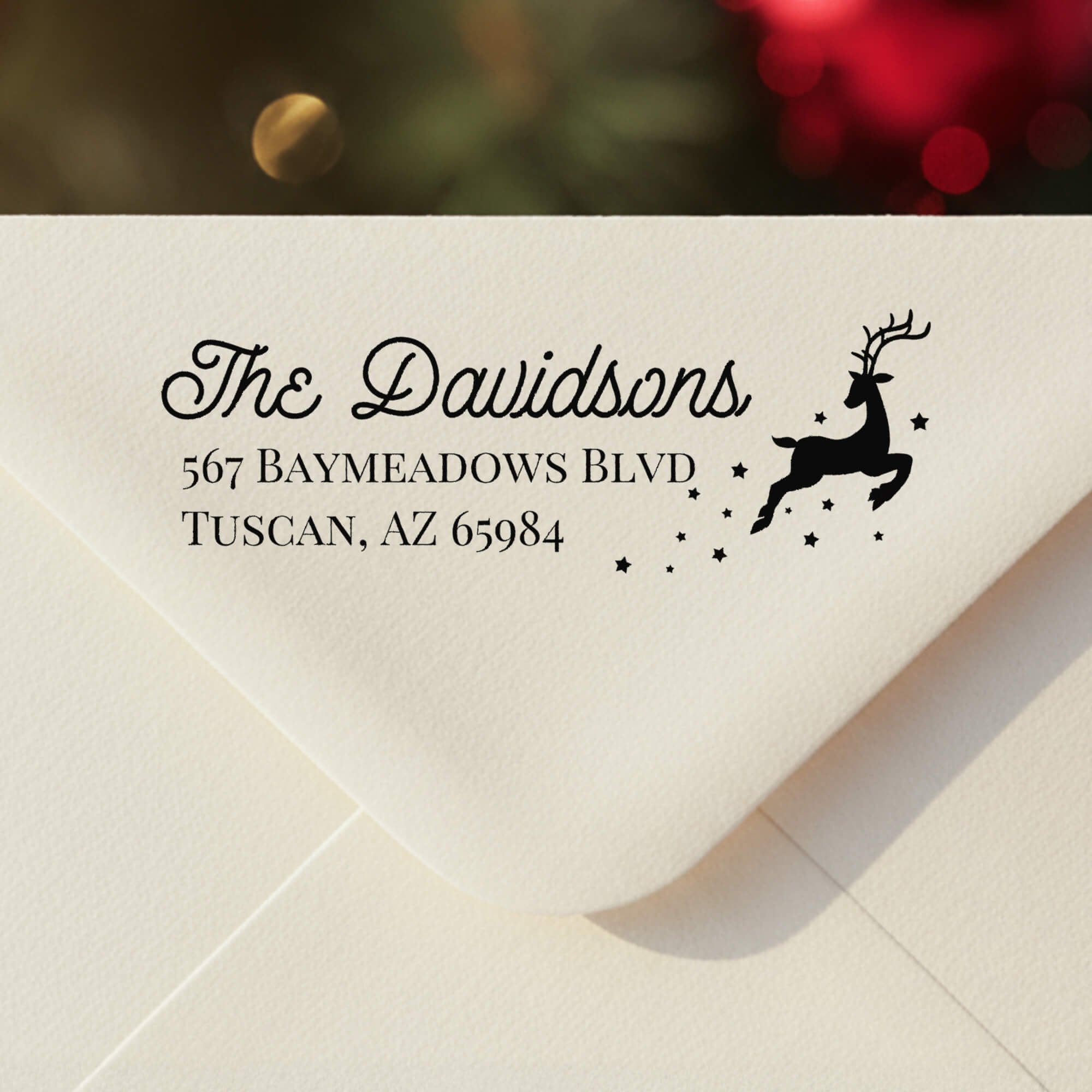 Personalized ‘Reindeer With Stars’ address stamp impression on envelope flap for holiday cards.