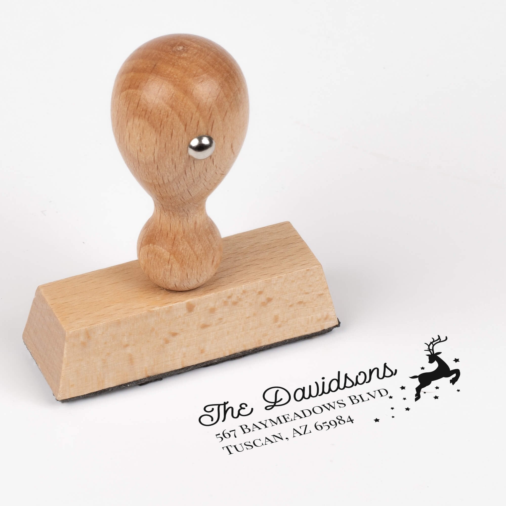 European wood hand stamp shown from above featuring custom ‘Reindeer With Stars’ holiday return address design.