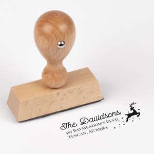European wood hand stamp shown from above featuring custom ‘Reindeer With Stars’ holiday return address design.