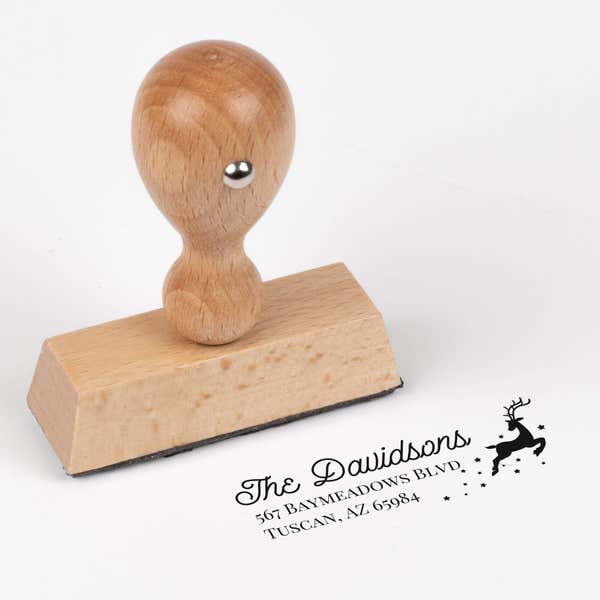 European wood hand stamp shown from above featuring custom ‘Reindeer With Stars’ holiday return address design.