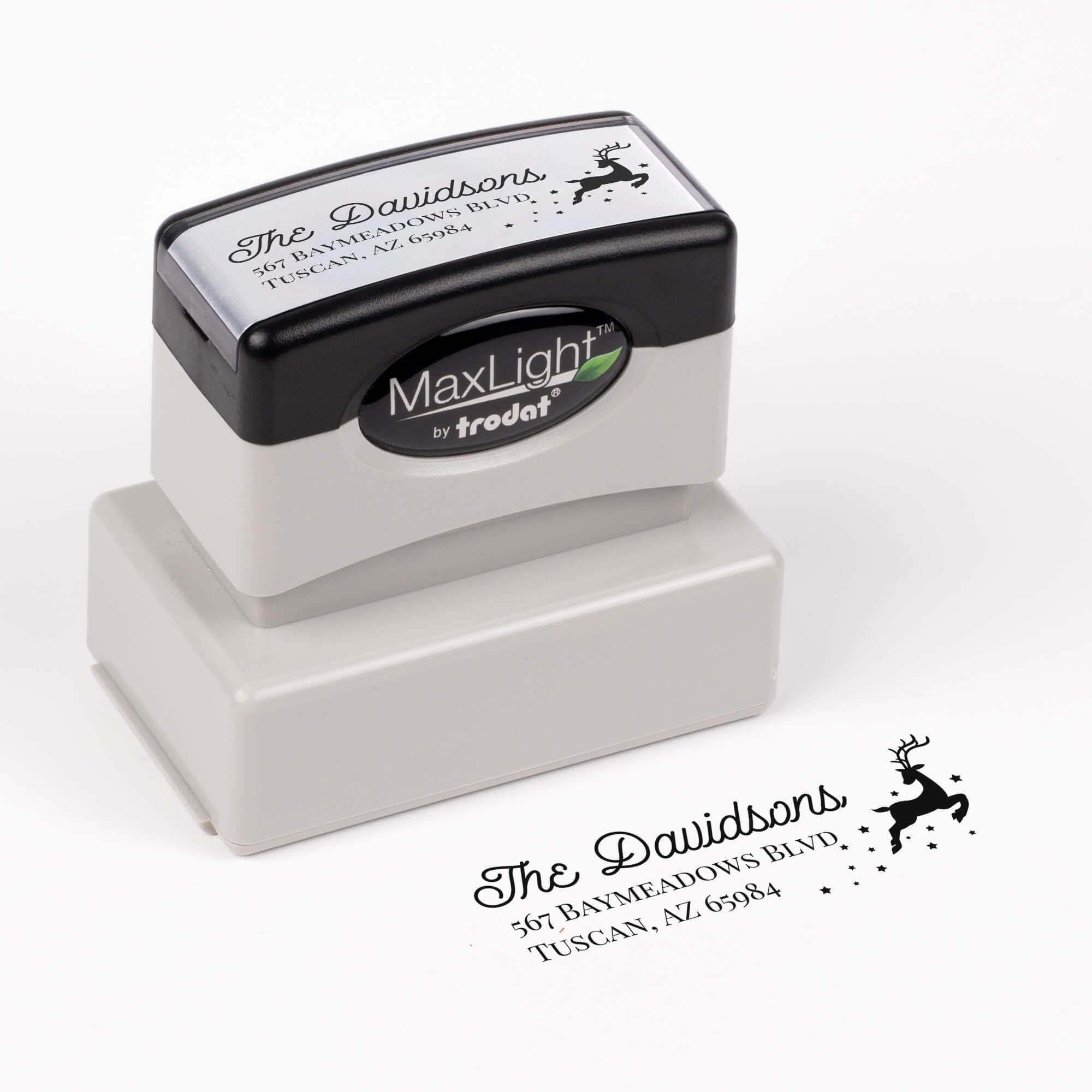 Pre-inked stamp shown from above featuring custom ‘Reindeer With Stars’  holiday return address design.