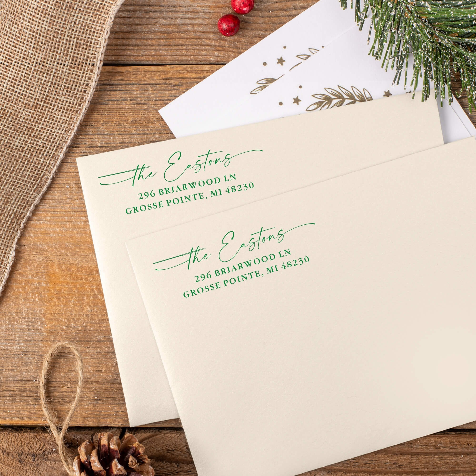 Green ink impressions of ‘Signature Script Family Name’ return address stamp on Christmas envelopes.