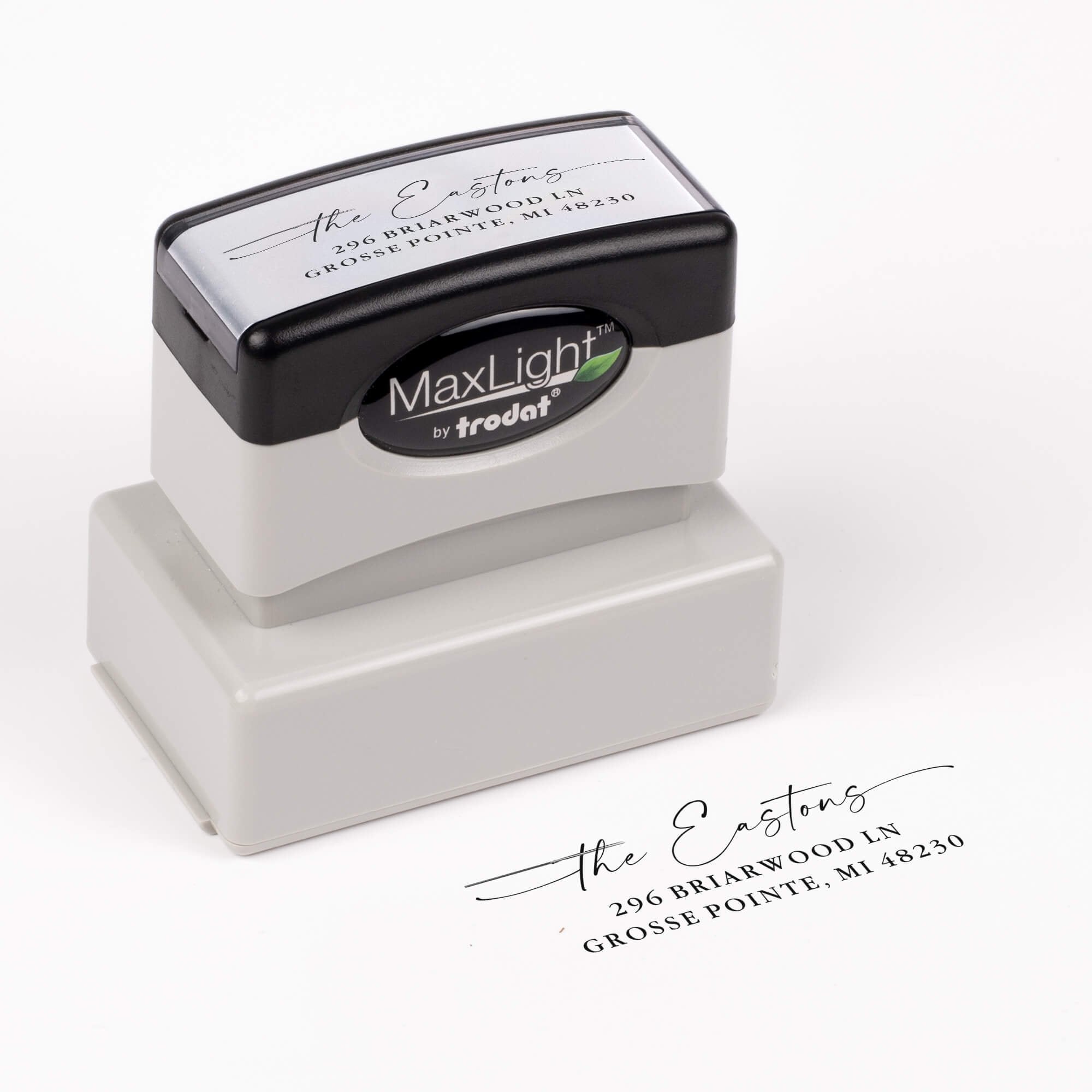 Pre-inked stamp shown from above featuring custom ‘Signature Script Family Name’  holiday return address design.