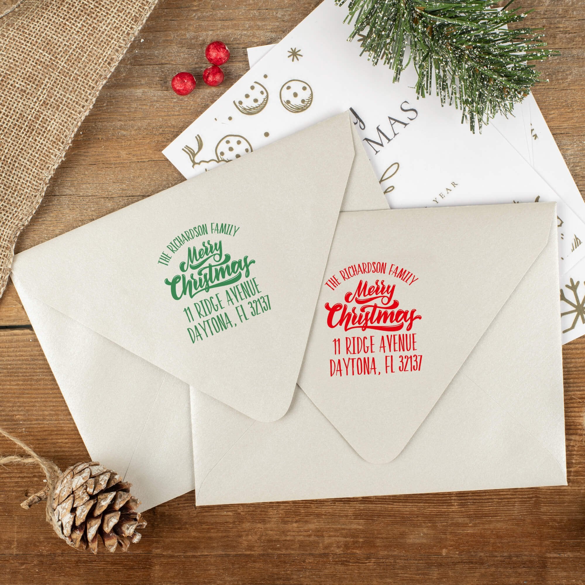 Green and red ink impressions of ‘Classic Merry Christmas’ return address stamp on Christmas envelopes.
