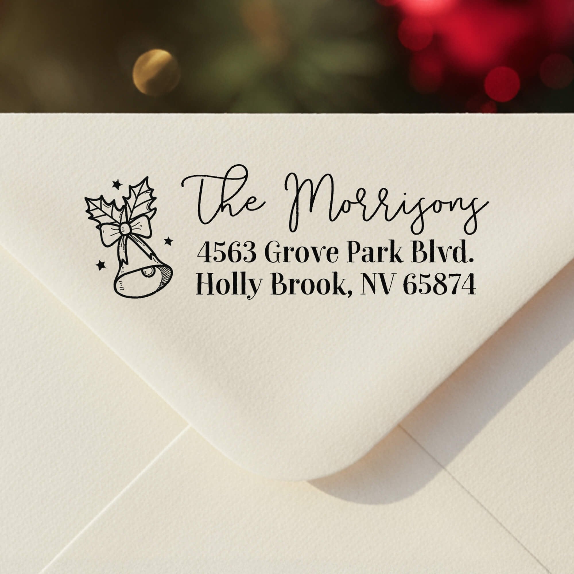 Holiday envelope stamped with personalized Christmas bell return address design and family name