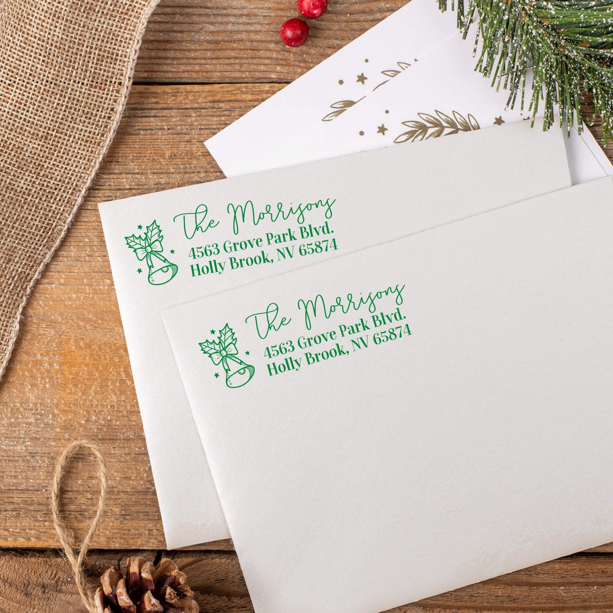 Holiday Bells Return Address Stamp in green ink on mail. 