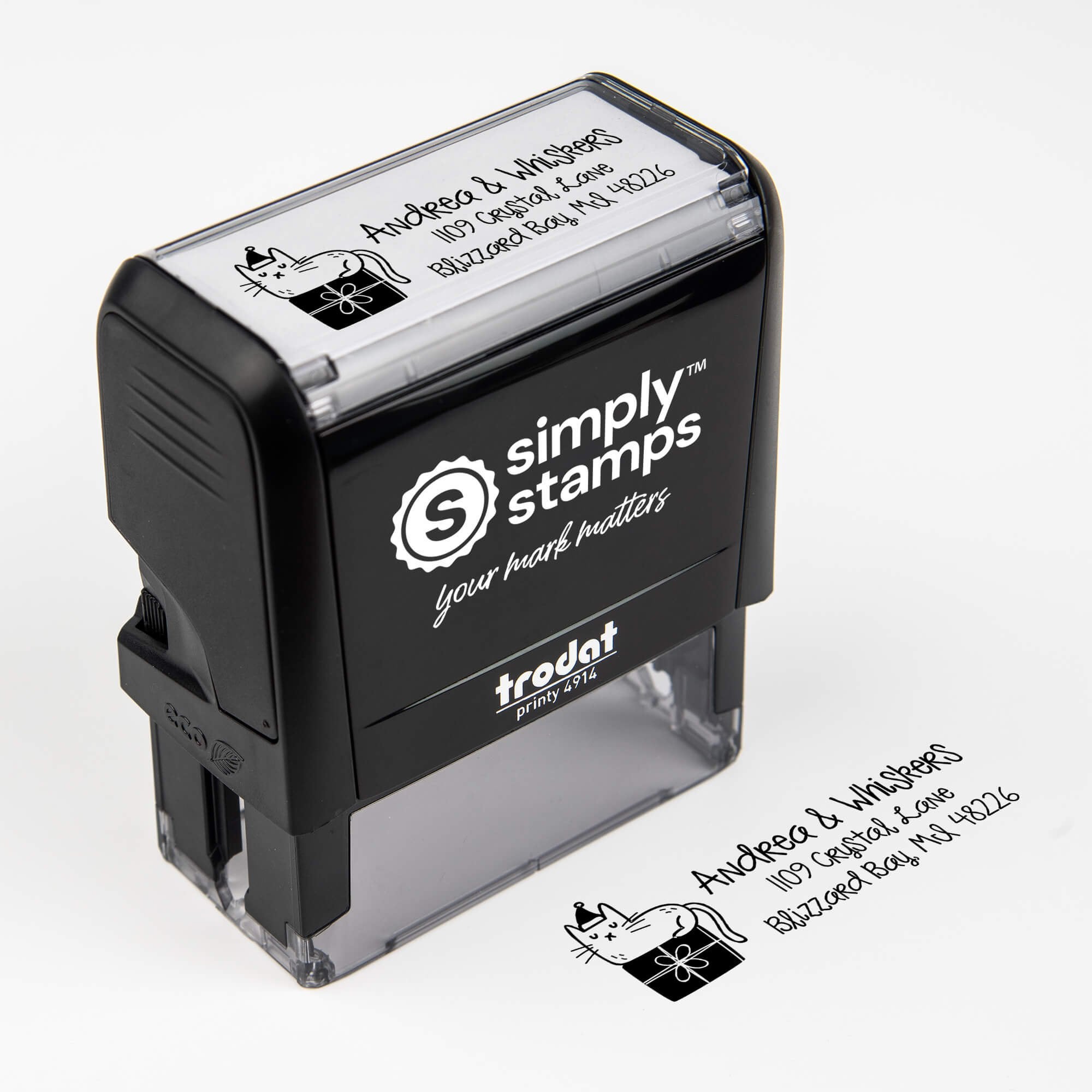 Top angle view of self-inking holiday stamp with circular ‘Holiday Cat’ address design.
