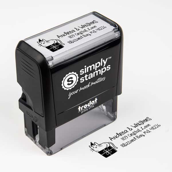 Top angle view of self-inking holiday stamp with circular ‘Holiday Cat’ address design.